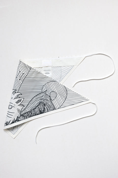 THE TWO OF CUPS triangular panel & bandana is made from leftover deadstock white cotton poplin. The bandana has an exclusive design inspired by tarot cards drawn by the artist Maria Robla and printed with black artisanal eco-friendly ink locally in Paris in collaboration with RoStudio. Wear the black and white bandana alone or attach it to the essential pieces to personalize them and wear them your unique way. Your perfect summer accessory.
