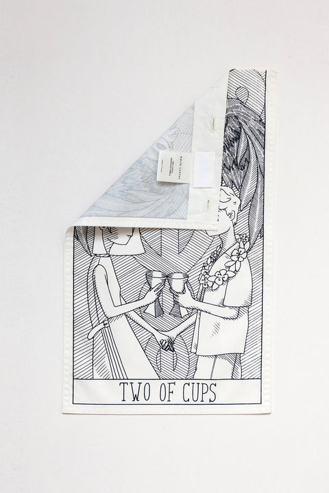 THE TWO OF CUPS vertical panel is made from leftover deadstock white cotton poplin. The panel has an exclusive design inspired by tarot cards drawn by the artist Maria Robla and printed with black artisanal eco-friendly ink locally in Paris in collaboration with RoStudio. Attach the black and white panel to the essential pieces to personalize them and wear them your unique way. Your perfect summer accessory.